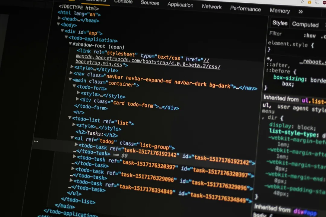 Developer reviewing website source code on a laptop during a CMS migration — evaluating WordPress alternatives for content teams